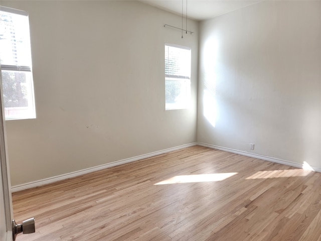 spare room with light wood-type flooring