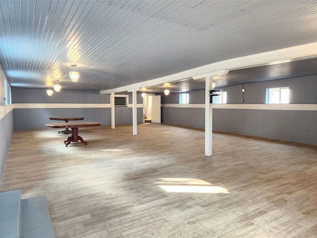 basement with light hardwood / wood-style floors