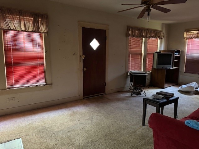 carpeted entrance foyer with ceiling fan