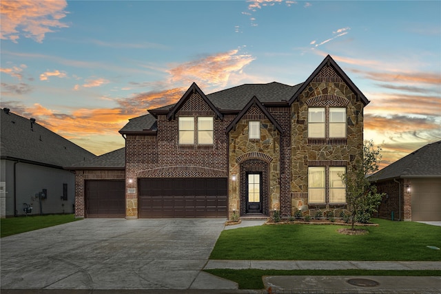 view of front of house featuring a garage and a yard