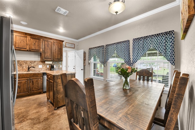 dining area featuring ornamental molding and sink