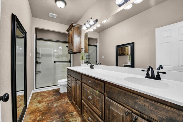 bathroom featuring dual vanity, an enclosed shower, tile flooring, and toilet