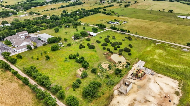 birds eye view of property with a rural view