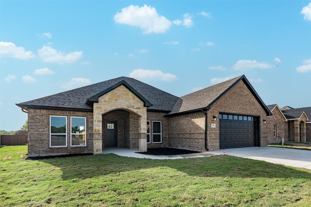 view of front of property with a garage and a front lawn