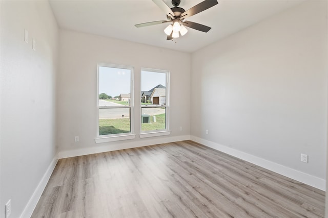 spare room with light hardwood / wood-style flooring and ceiling fan