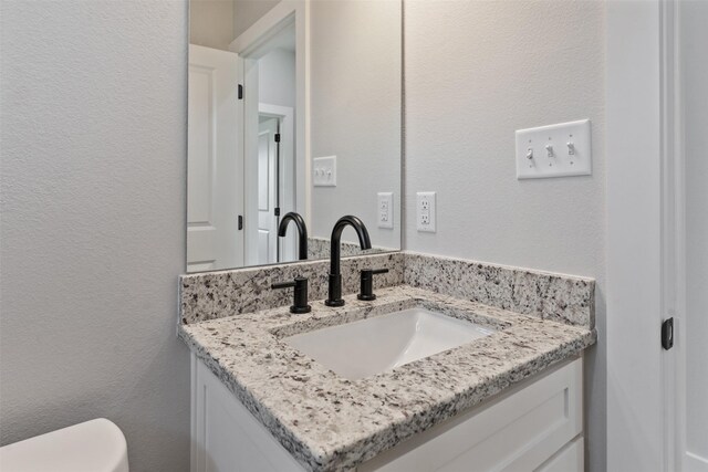 bathroom with toilet and vanity