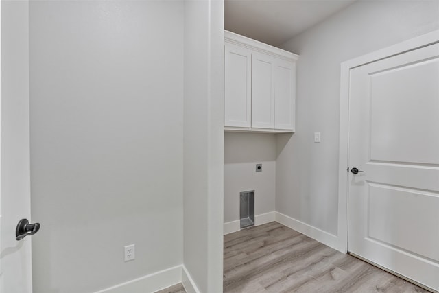 clothes washing area with light hardwood / wood-style floors, cabinets, and hookup for an electric dryer