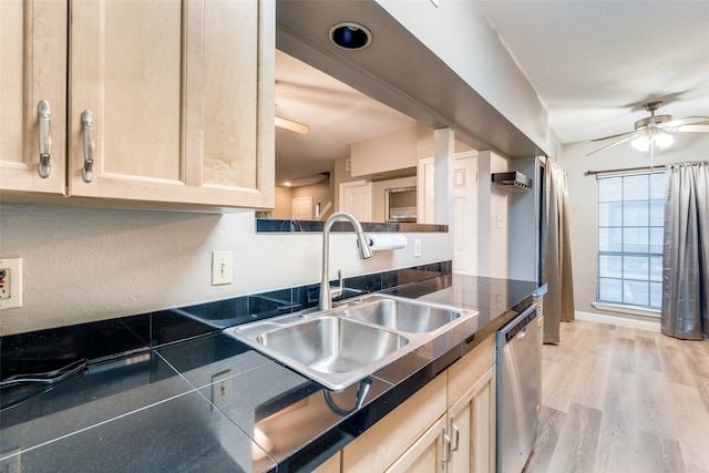 kitchen with light brown cabinets, ceiling fan, dishwasher, light wood-type flooring, and sink