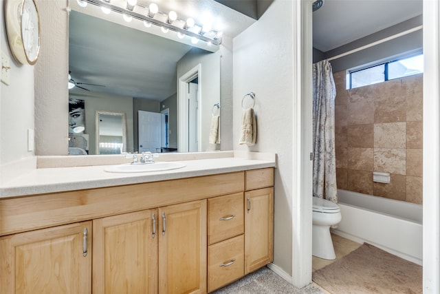 full bathroom featuring tile flooring, ceiling fan, shower / bath combo with shower curtain, vanity, and toilet