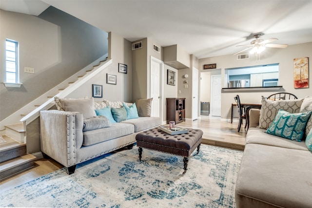 living room with wood-type flooring and ceiling fan