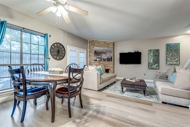 dining space featuring ceiling fan, hardwood / wood-style flooring, and french doors