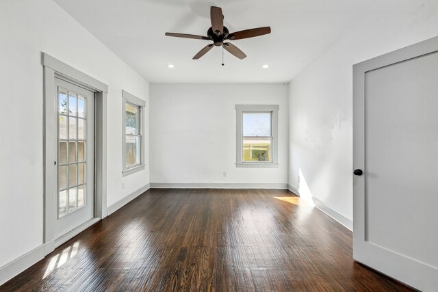 spare room with a healthy amount of sunlight, wood-type flooring, and ceiling fan