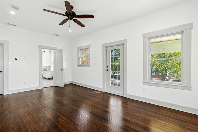 unfurnished living room featuring ceiling fan and dark hardwood / wood-style flooring