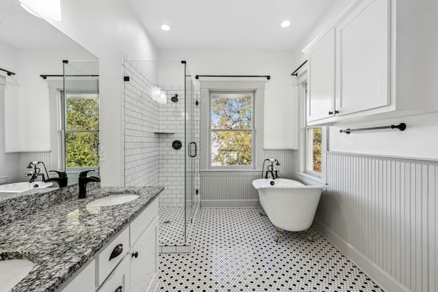 bathroom with tile floors, shower with separate bathtub, and double vanity