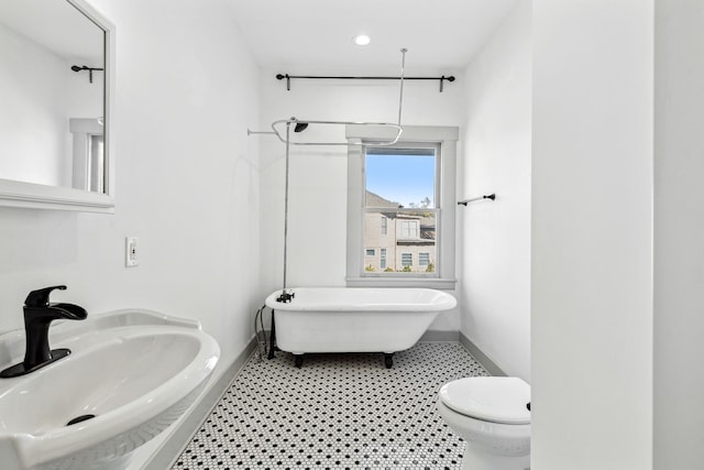 bathroom featuring sink, a bathtub, tile flooring, and toilet