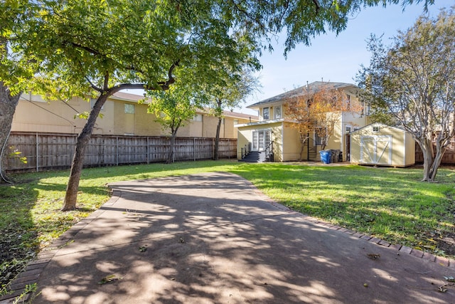 exterior space featuring a storage shed and a front yard