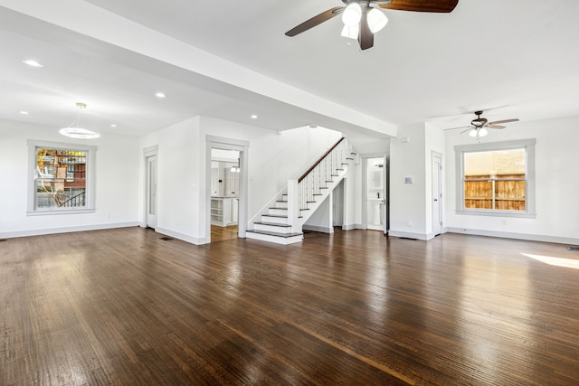 unfurnished living room with dark hardwood / wood-style flooring, ceiling fan, and plenty of natural light