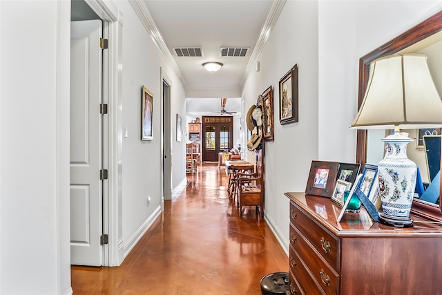 corridor with concrete floors, ornamental molding, and french doors