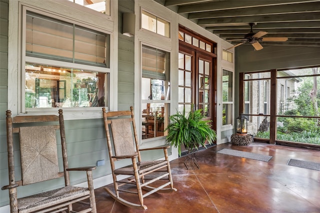 sunroom with vaulted ceiling with beams, ceiling fan, and plenty of natural light