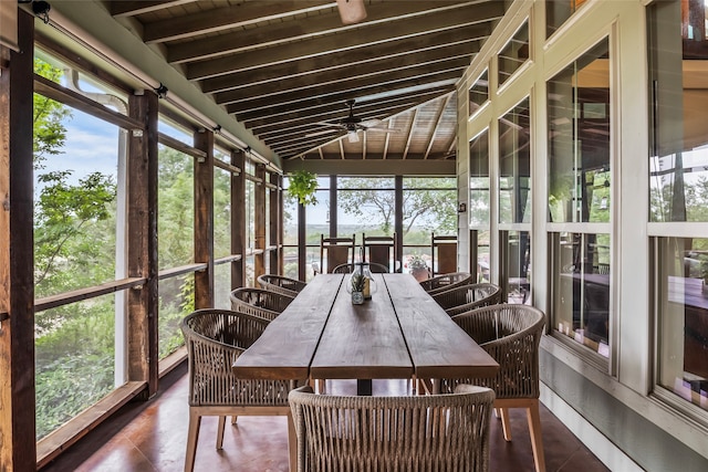 sunroom / solarium featuring lofted ceiling with beams and plenty of natural light