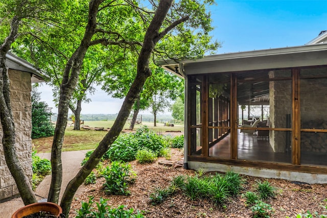 view of yard featuring a sunroom