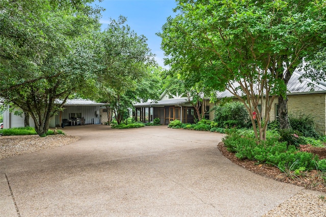 view of front of property with a carport and a sunroom