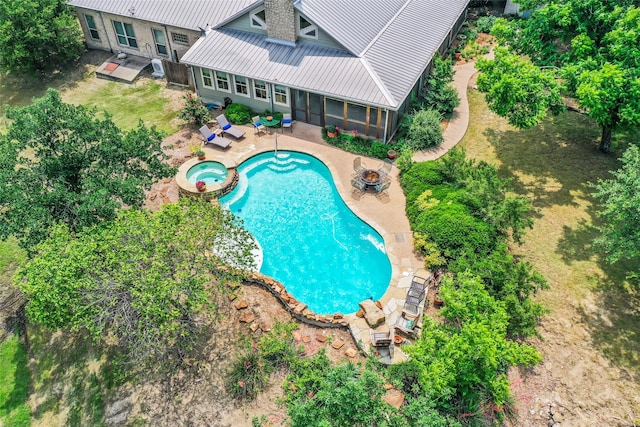 view of swimming pool with a patio area, an in ground hot tub, and a sunroom