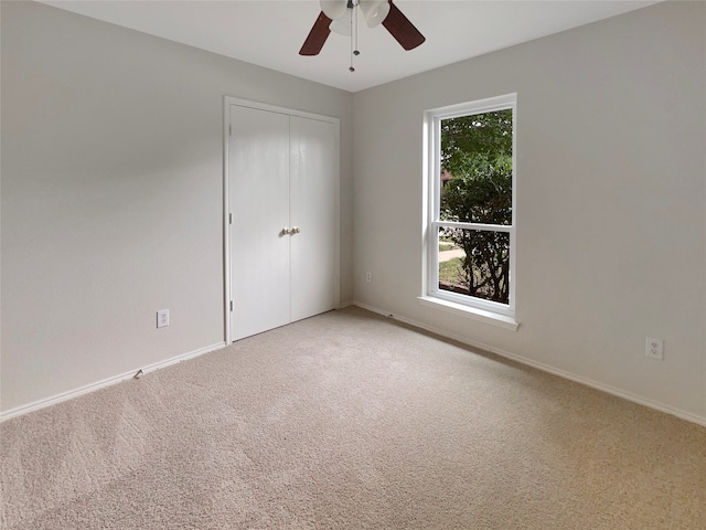 spare room with carpet flooring, plenty of natural light, and ceiling fan