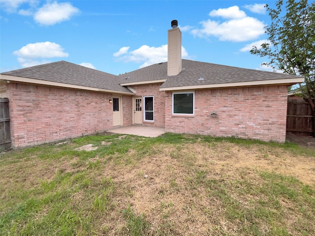 rear view of house featuring a patio and a yard