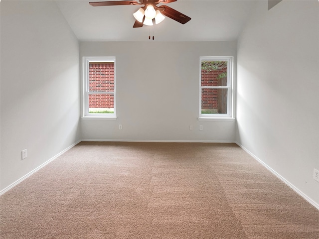 carpeted spare room with ceiling fan