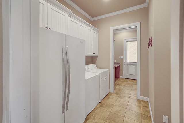 laundry room with cabinets, crown molding, washer and dryer, and light tile patterned floors