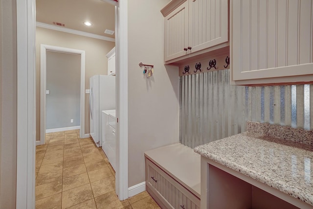 mudroom featuring light tile patterned flooring and ornamental molding