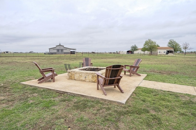 view of patio featuring a rural view and a fire pit