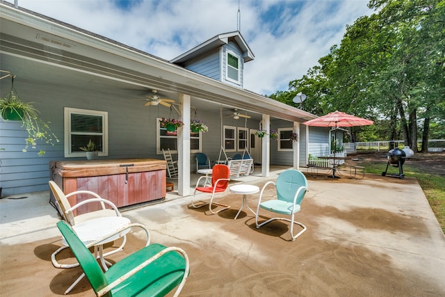 view of terrace with a hot tub and ceiling fan