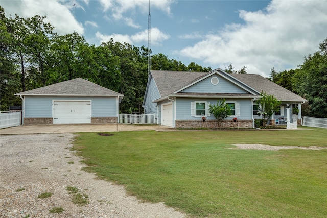 view of front facade with an outdoor structure, a garage, and a front lawn