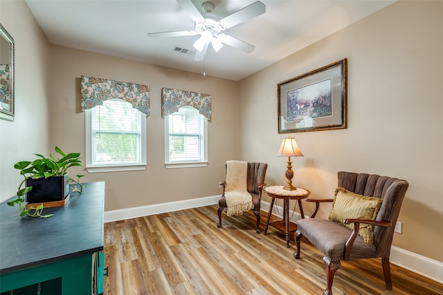 living area with ceiling fan and hardwood / wood-style floors