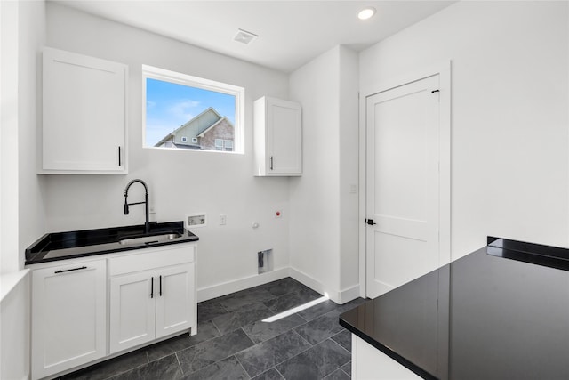 washroom with sink, cabinets, hookup for an electric dryer, hookup for a gas dryer, and hookup for a washing machine