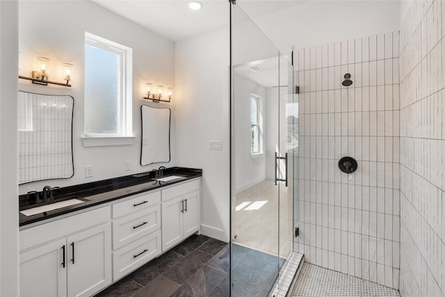 bathroom featuring vanity and tiled shower