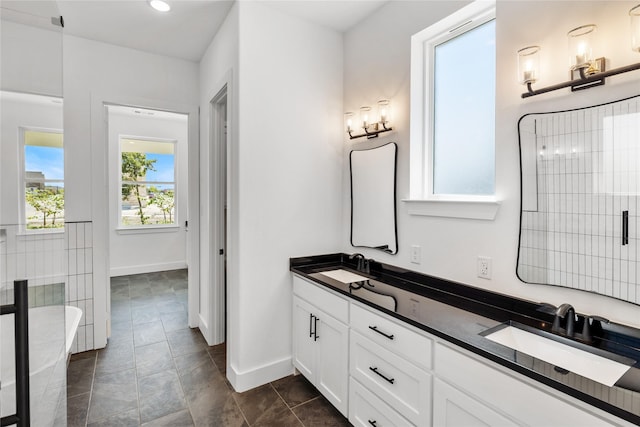 bathroom featuring tile patterned flooring, vanity, and an enclosed shower