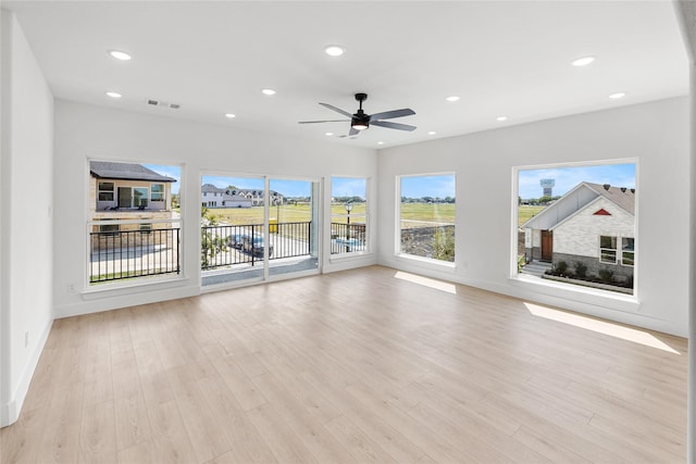 unfurnished living room with ceiling fan and light hardwood / wood-style floors