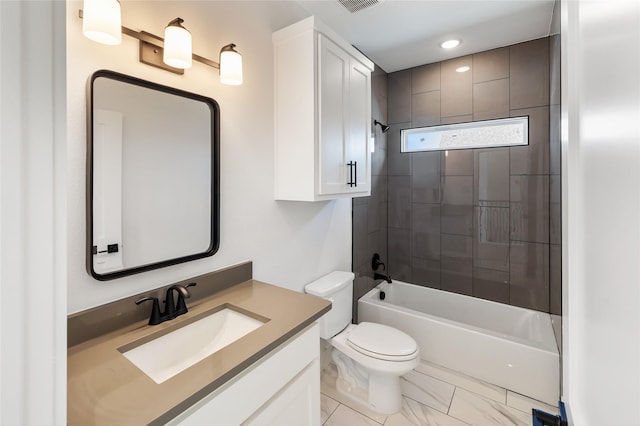 full bathroom featuring vanity, tiled shower / bath combo, and toilet