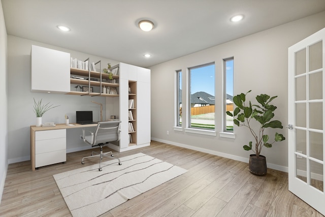 office area featuring light wood-type flooring and built in desk