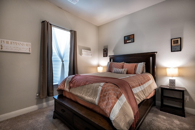 bedroom with baseboards and dark carpet