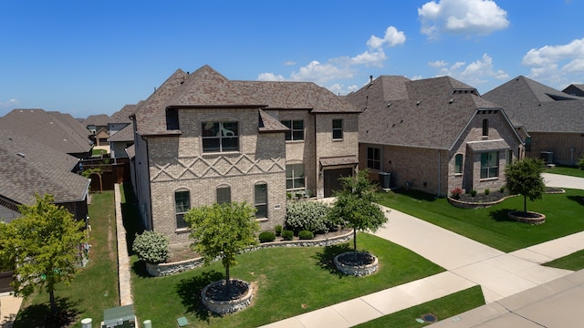 french provincial home featuring brick siding, concrete driveway, roof with shingles, a residential view, and a front yard