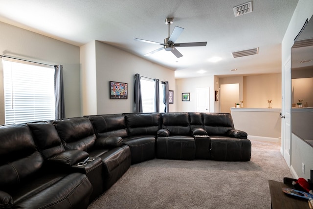 living area with baseboards, visible vents, a ceiling fan, and light colored carpet