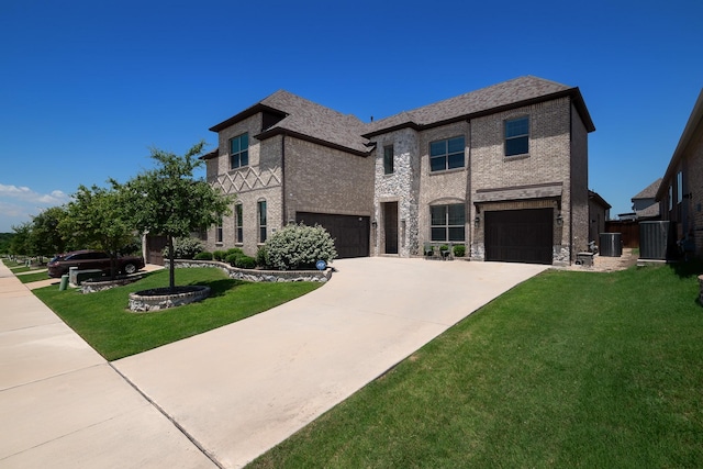 view of front of home featuring an attached garage, driveway, a front lawn, and brick siding