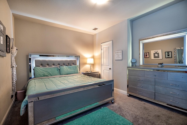 bedroom featuring carpet floors, visible vents, and baseboards