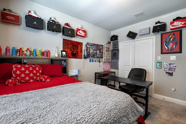 carpeted bedroom featuring baseboards, visible vents, and a closet