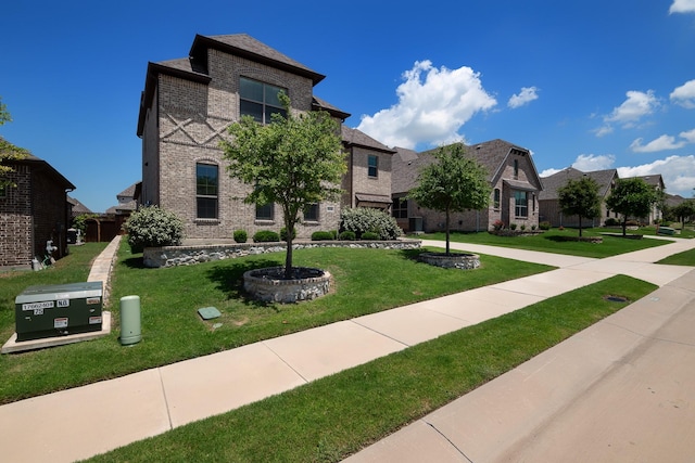 view of front of home featuring a residential view, a front lawn, and brick siding