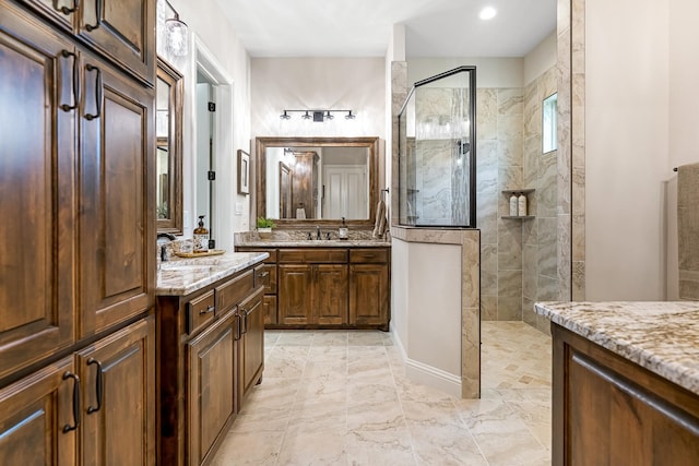 bathroom featuring tile flooring, a shower with shower door, and vanity